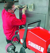 Photo of a worker using a flexible shaft grinder