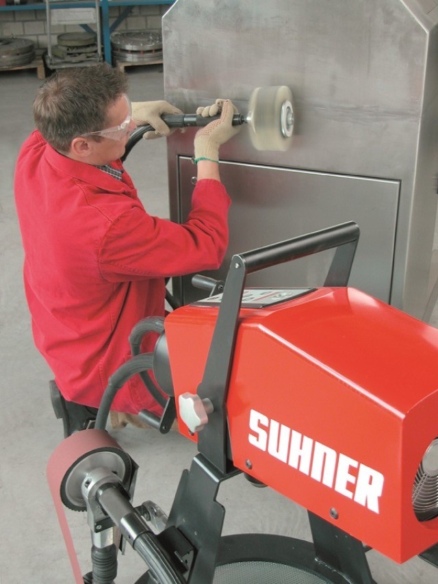 Man using a Suhner flexible shaft grinder