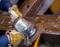 Photo of a worker's hands using a vertical grinder